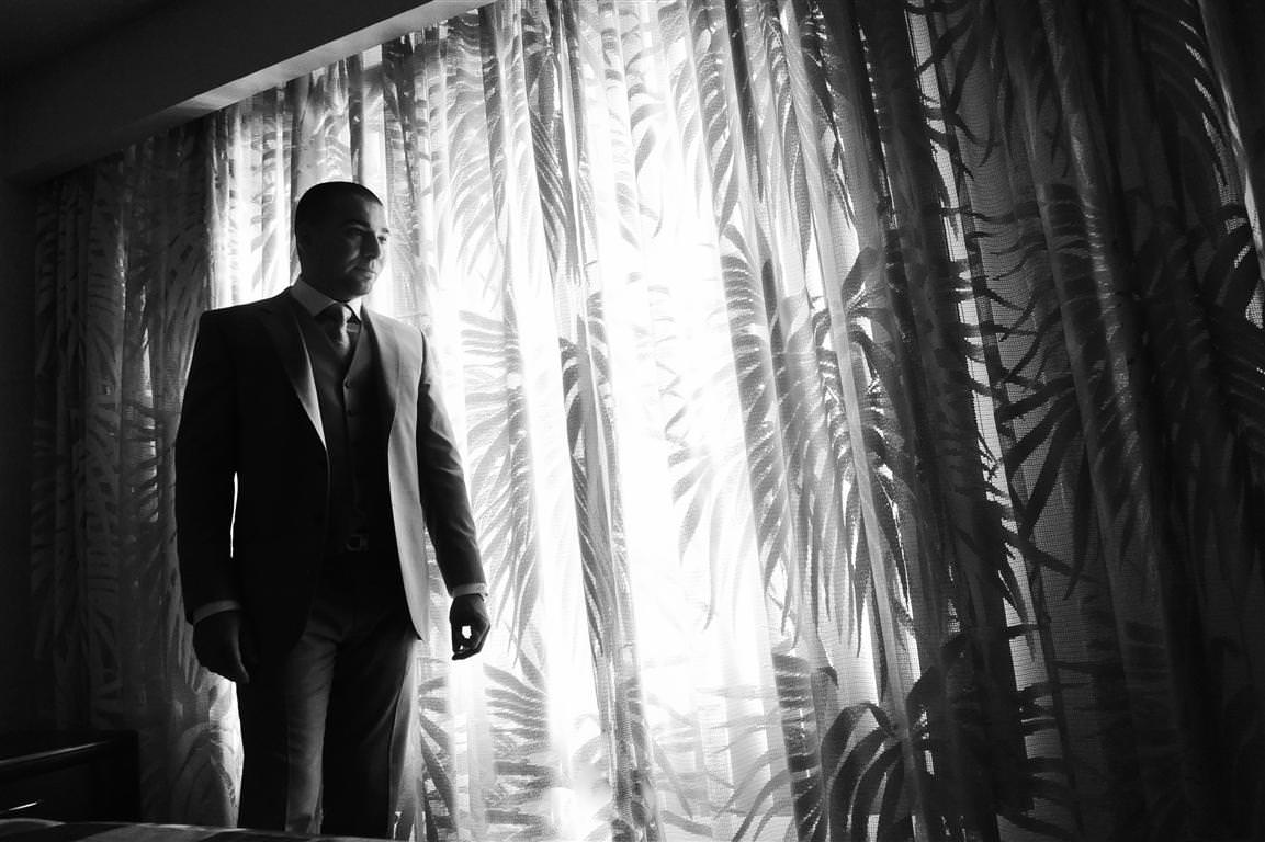 astonishing wedding groom artistic portrait with curtains black white shot by lavimage montreal