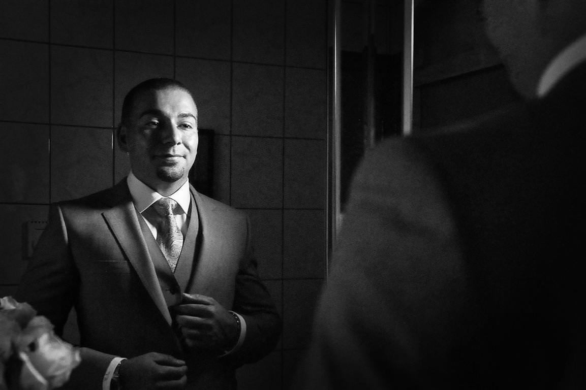 astonishing wedding getting ready groom artistic portrait with mirror reflection black white shot by lavimage montreal