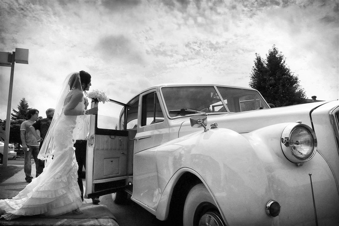 astonishing wedding bride gets into white car black white artistic shot by lavimage montreal