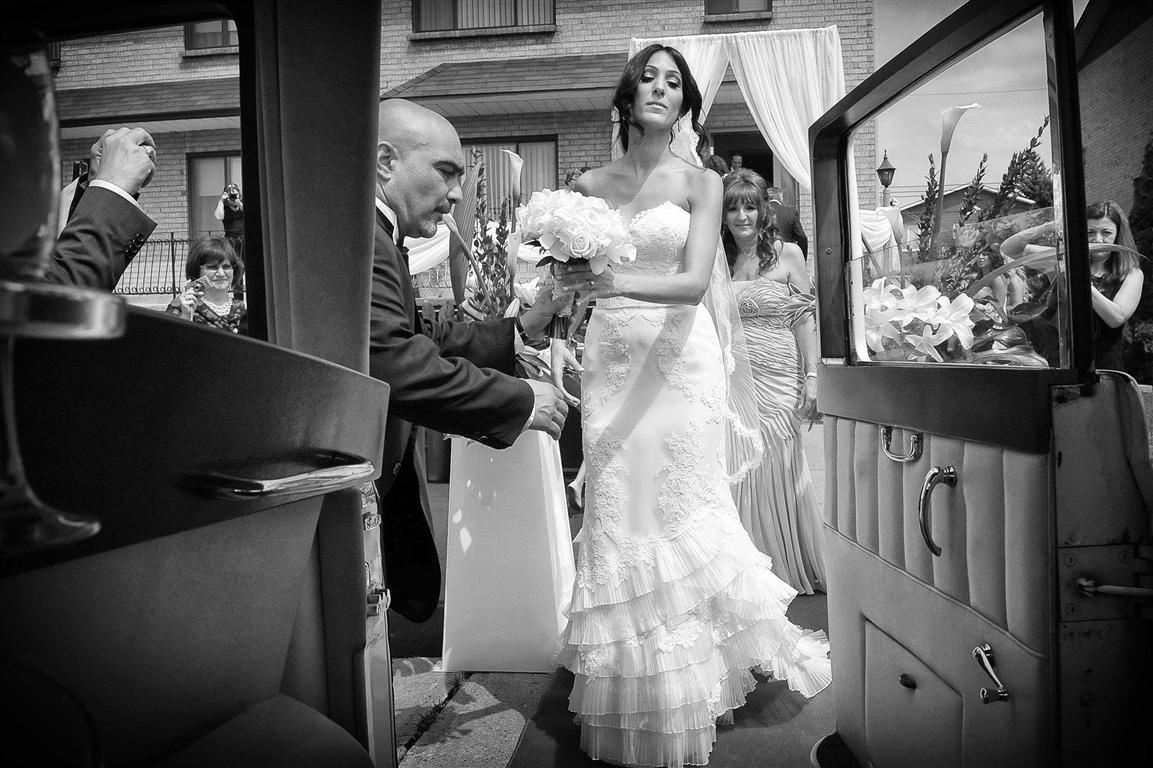 astonishing wedding bride gets into white car doorview black white wedding photo by lavimage montreal