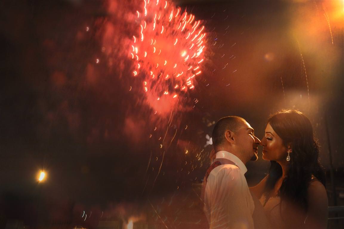 astonishing wedding reception evening bride groom romantic kiss with fireworks on background colored photo by lavimage montreal