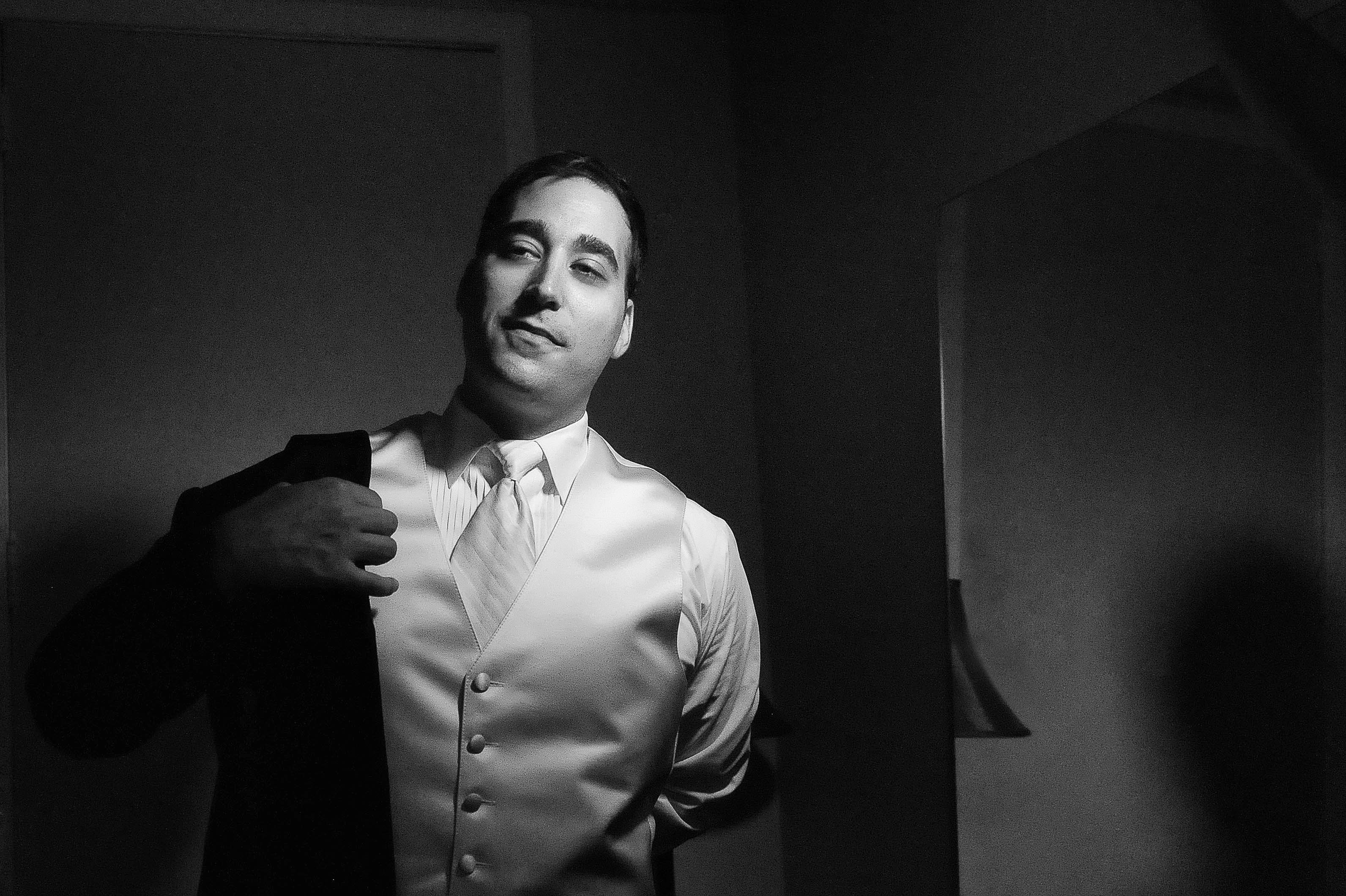 charming wedding getting ready groom standing in white jacket black white photo by lavimage montreal