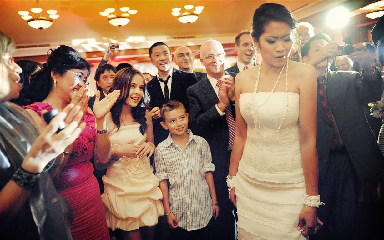 heavenly wedding reception bride surrounded by guests colored shot by lavimage montreal