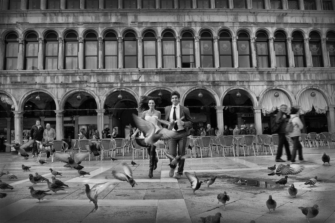 destination wedding couple together running down piazza san marco by lavimage montreal