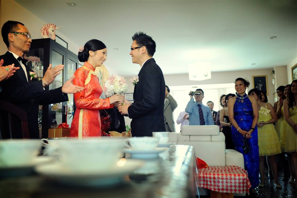 chinese tea wedding ceremony groom gives flowers to bride by lavimage montreal