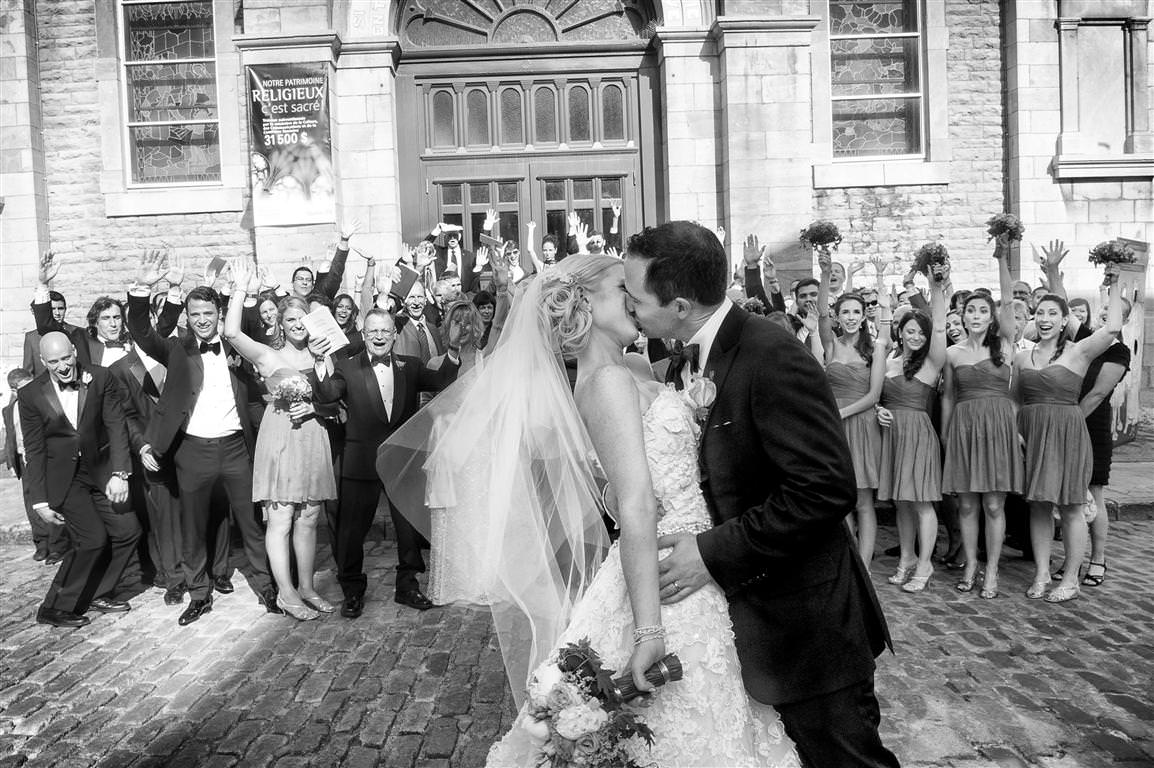 black white wedding photos bride groom kiss guests happiness by lavimage montreal