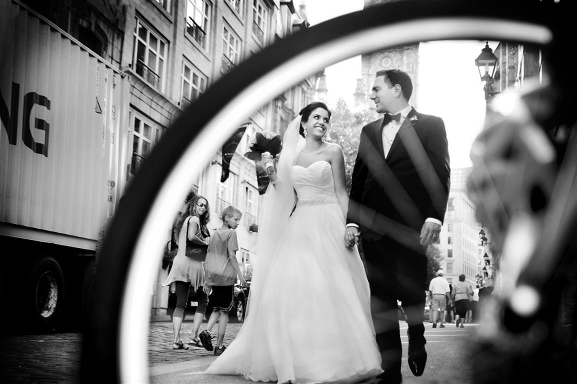 black and white wedding pictures couple together city walk veiw through bicycle wheel by lavimage montreal