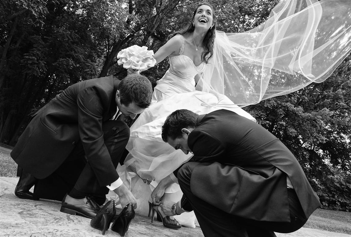 black white wedding photos groom best man helping bride with shoes by lavimage montreal