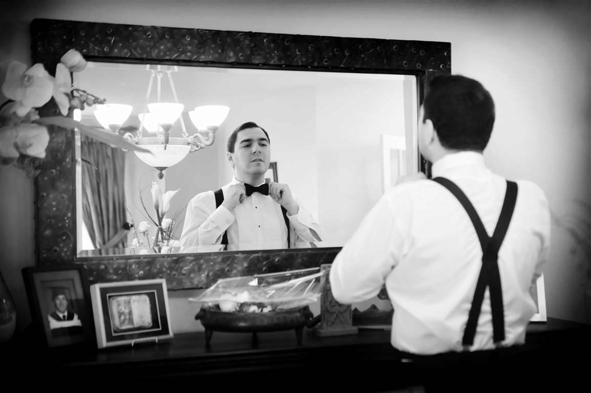 black and white wedding pictures getting ready groom facing mirror by lavimage montreal