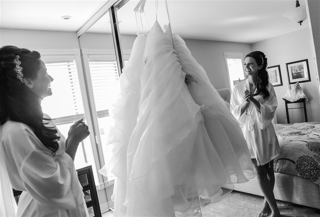 Bride looks at her wedding dress  at the Golf St Raphael photographed by La V image wedding photographer montreal