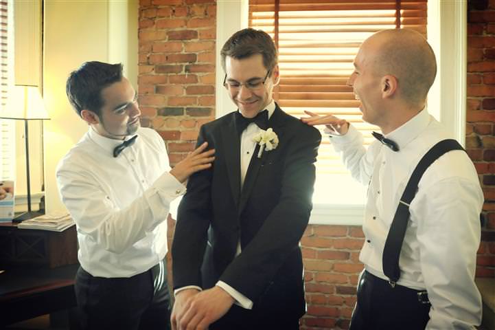 Friends helping groom to get ready - Wedding at the Science Centre Montreal by La V image-Montreal wedding photographer