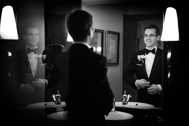 groom looking in the mirror Wedding at the Science Centre Montreal by La V image-Montreal wedding photographer