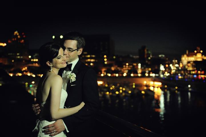 Portrait of bride and groom hugging with a background of the city of Montreal at night Wedding at the Science Centre Montreal by La V image-Montreal wedding photographer