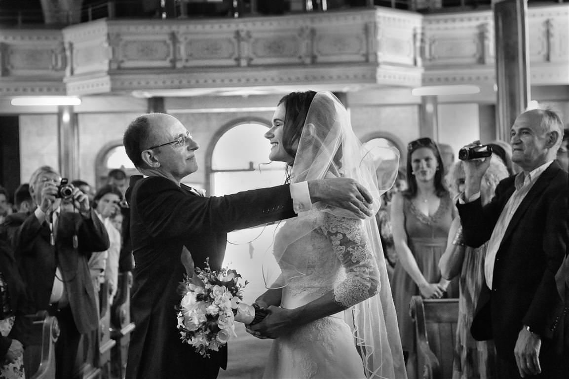 Parents at wedding-big momentt-father takes off the veil off the bride in a church by La V image Montreal wedding photographer