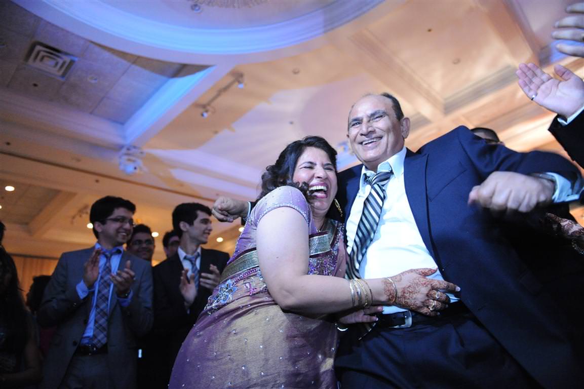 Parents at wedding-Parents dancing Indian traditions by La V image Montreal wedding photographer