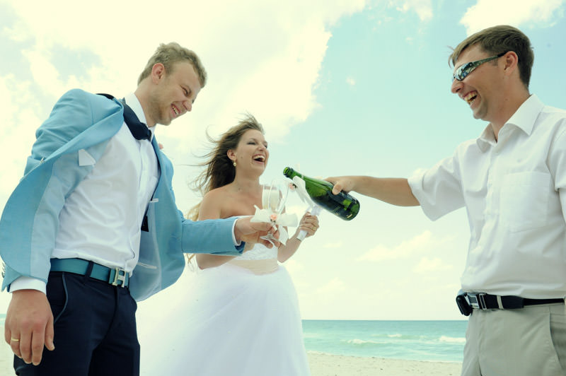 bride and groom drinking champaign at the wedding ceremony at the beach destination wedding in Cuba by La V image photography - Montreal wedding photograpgher
