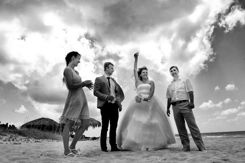 bride and groom having fun with friendsat the wedding ceremony at the beach destination wedding in Cuba by La V image photography - Montreal wedding photograpgher