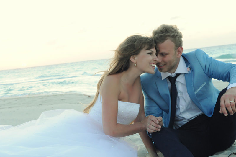 bride and groom sitting at the beach  at the romantic session in the city of Varadero at the destination wedding in Cuba by La V image photography - Montreal wedding photograpgher