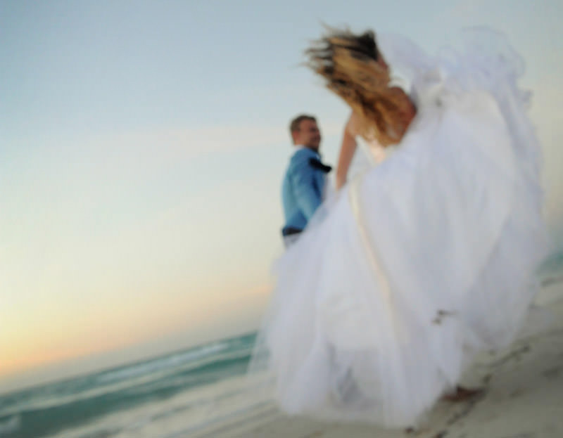 bride and groom running at the beach  at the romantic session in the city of Varadero at the destination wedding in Cuba by La V image photography - Montreal wedding photograpgher