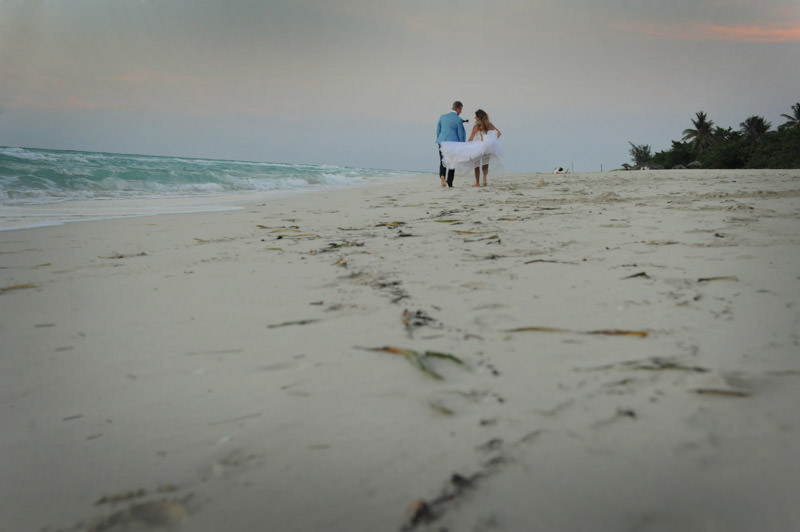 bride and groom walking at the beach  at the romantic session in the city of Varadero at the destination wedding in Cuba by La V image photography - Montreal wedding photograpgher