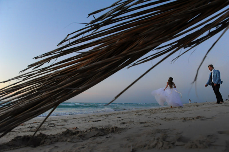 bride and groom walking at the beach  at the romantic session in the city of Varadero at the destination wedding in Cuba by La V image photography - Montreal wedding photograpgher