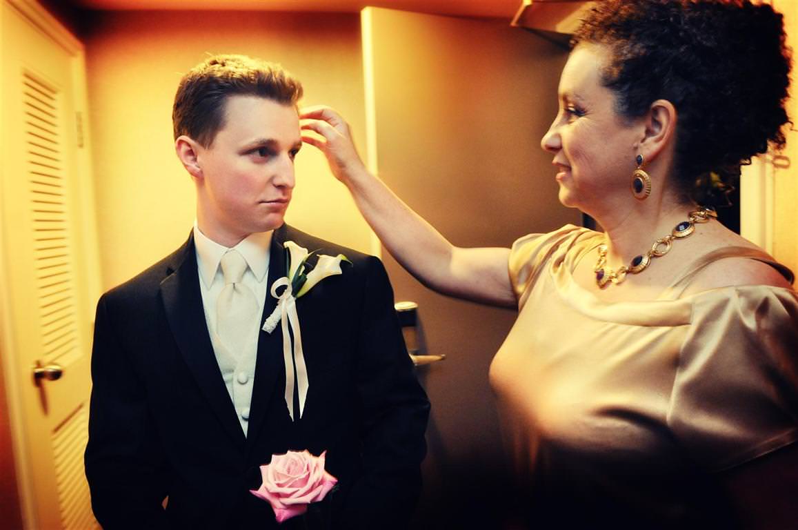 Parents at wedding-Mother of the groom helps her son to get ready by La V image Montreal wedding photographer